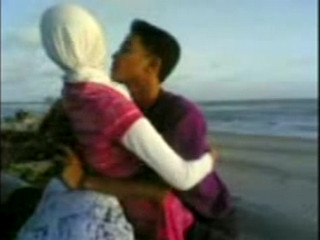 indonesian hijabi girl at the seaside with lover